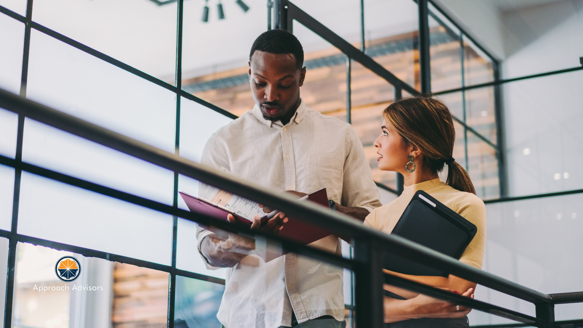wo professionals reviewing financial documents while walking through a modern office, illustrating the connection between Financial Planning and Operational Efficiency