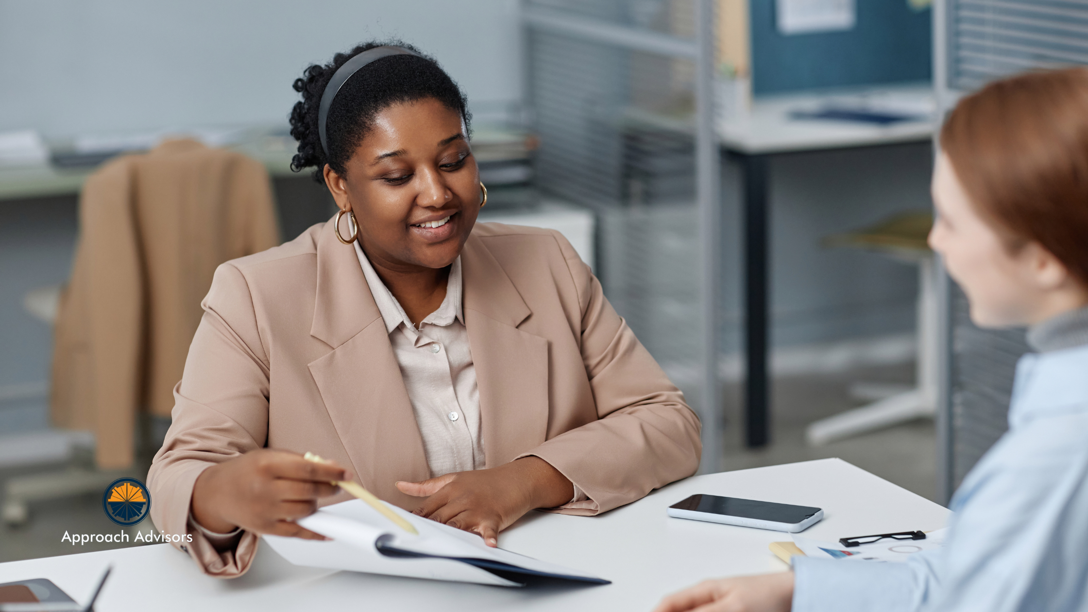 Business advisor discussing financial planning and operational efficiency strategies with a client in a modern office setting.
