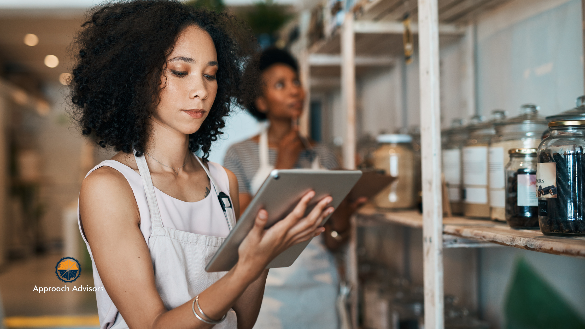 Small business owner using a digital tablet for inventory review as part of Financial Planning in a retail store.
